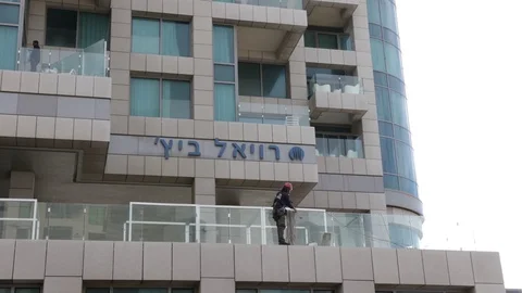 Rock climber in a skyscraper Stock Footage 128715005