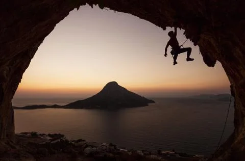 Rock climber at sunset. Stock Photos