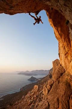 Rock climber at sunset Stock Photos