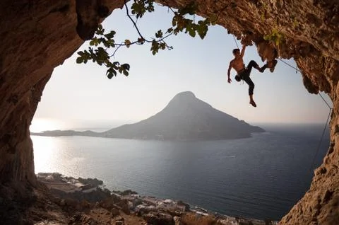 Rock climber at sunset. Stock Photos