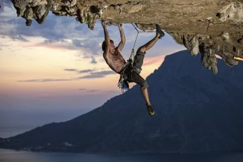 Rock climber at sunset Stock Photos
