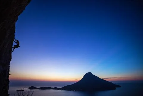 Rock climber at sunset Stock Photos