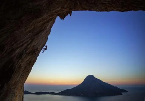 Rock climber at sunset Stock Photos