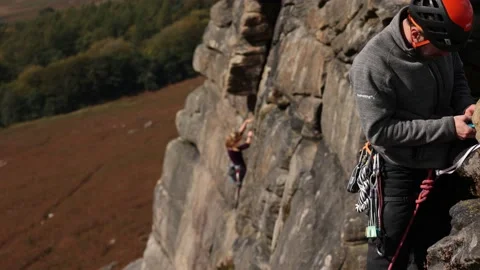 Rock climber tying rope off Stock Footage 140518604