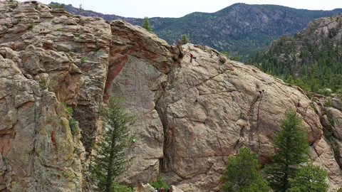 Rock climbers make their way up a steep ascent in Colorado Stock Footage 247363897