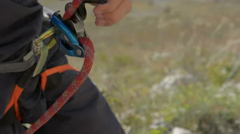 Rock climbing belay device lowering partner HD Stock Footage 33531364
