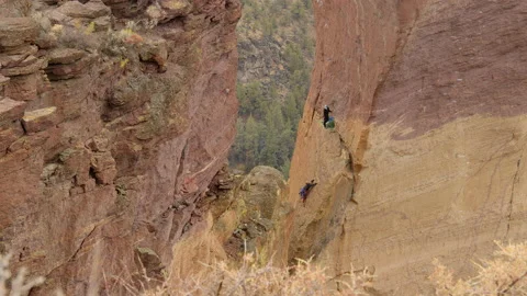 Rock climbing couple ascending Monkey Face, Smith Rock State Park, Oregon Stock Footage 227837824