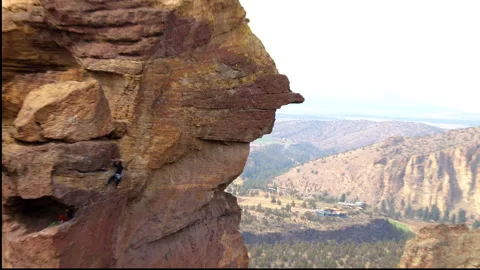 Rock climbing couple ascending Monkey Face, Smith Rock State Park, Oregon Stock Footage 227951648