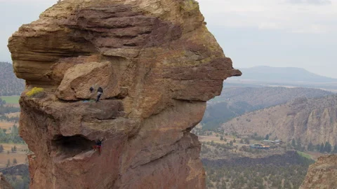 Rock climbing couple ascending Monkey Face, Smith Rock State Park, Oregon Stock Footage 227958798
