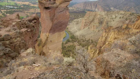 Rock climbing couple rappelling off Monkey Face, Smith Rock State Park, Oregon Stock Footage 228459076