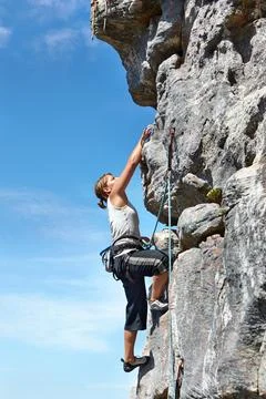 Rock climbing, explore and challenge with woman on mountain for adventure Foto stock
