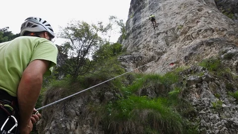Rock climbing, scene from below, clipped to the wall Stock Footage 107990917