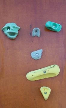 Rock climbing wall with colorful knobs Stock Photos