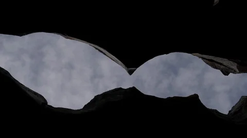 Rock crack and clouds background 4k Видео 106017497