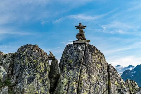 A rock with a cross on top of it Stock Photos
