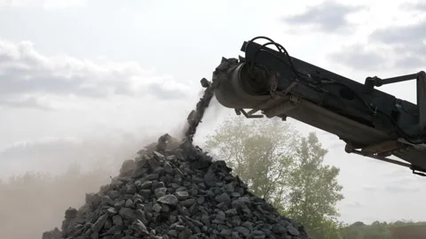 Rock crushing equipment crushes stone into gravel in open pit quarry mine Stock Footage 243147553