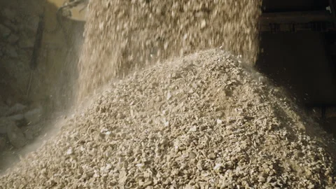 Rock crushing machine at work in quarry, stone pieces falling on pile, close up Video stock 294072187