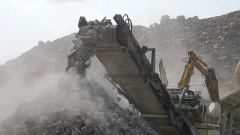 Rock crushing machinery at work in open pit mine crushing stone into gravel Stock Footage 243147557