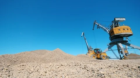 Rock excavation site with functioning vehicles 動画素材 114303090