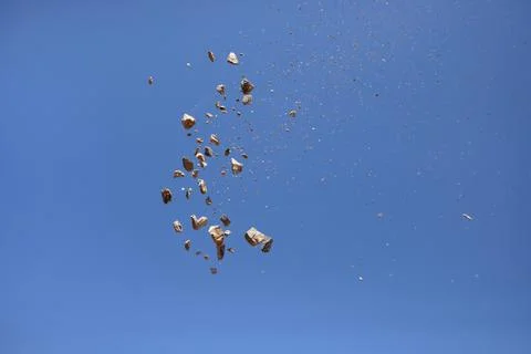 Rock exploding into fragments in the sky Stock Photos