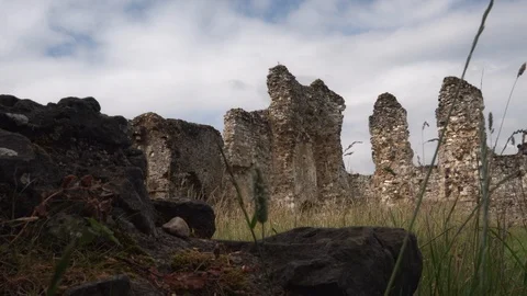 Rock in foreground and stone ruin in background Stock Footage 123758024