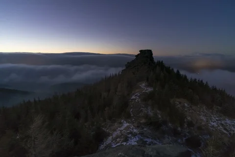 Rock formation after the sunset above the clouds 8k Stock Footage 124997673