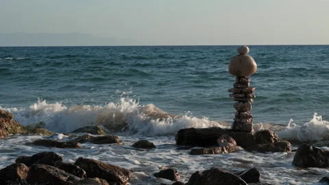 A rock formation is on the beach next to the ocean Stock Footage 272320454
