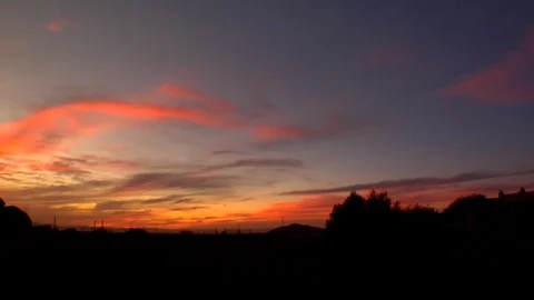 Rock formation boulder against setting sun sky red clouds Stock Footage 125274502