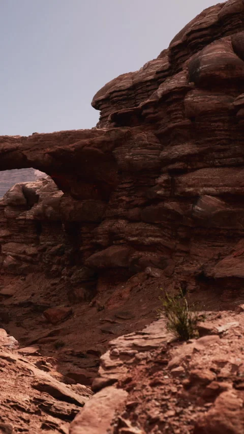Rock formation at canyon with arch under clear sky Stock Footage 346758822