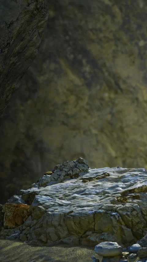 Rock formation in a cave with light shining on the surface during daytime Stock Footage 334258303