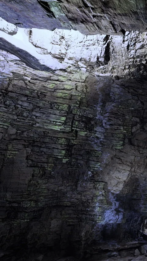 Rock formation in a cave showing layers and light from above Stock Footage 331752277