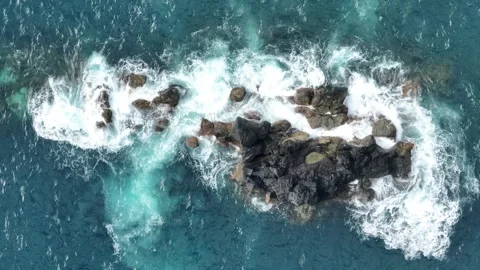 Rock Formation Off Coast With Waves Rolling Over Stockbeeldmateriaal 249202145