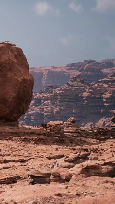 Rock formation in a desert area showing cliffs and a large boulder Stock Footage 346677989