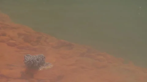 Rock formation on edge of geothermal hot pool Stock Footage 3017755