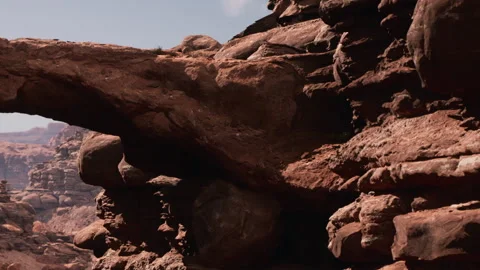 Rock formation with large arch in desert landscape during sunny day Stock Footage 338324840