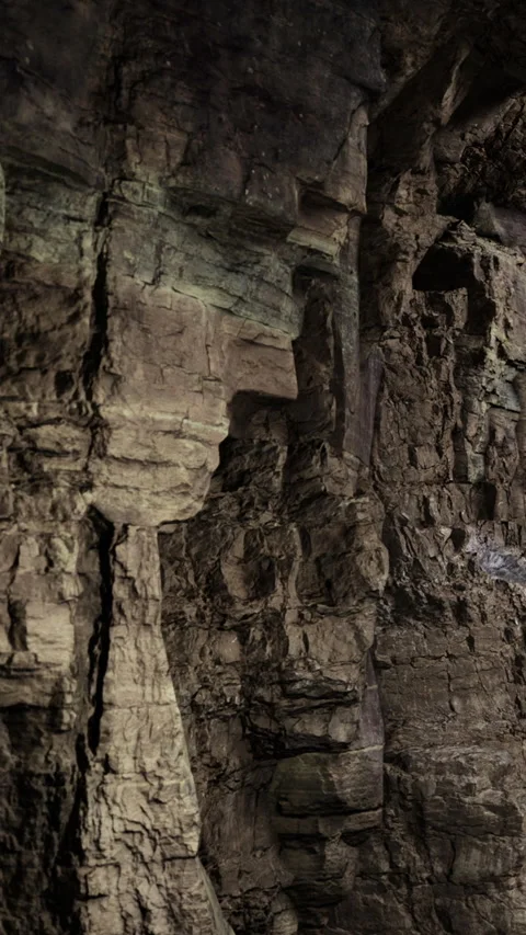 Rock formation resembling a face seen in a cave during daylight hours Stock Footage 331750369