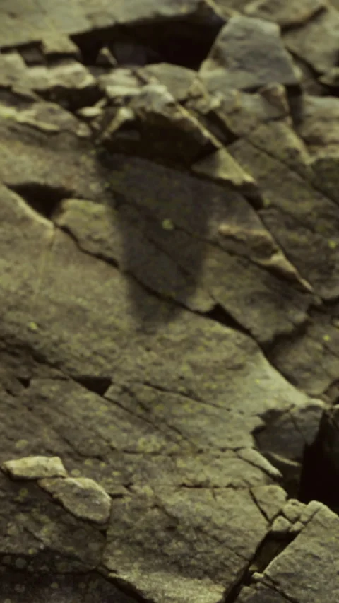 Rock formation with shadows visible on surface during midday light Stock Footage 334193116