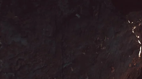 Rock formation showing different textures and shadows in a cave setting Stock Footage 344059921