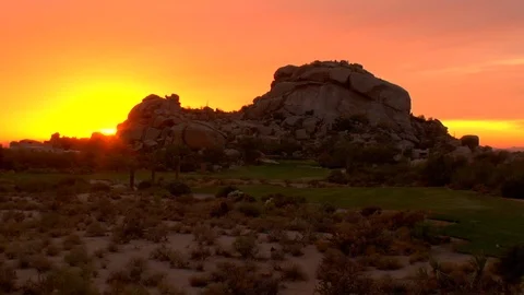 Rock formation shrubs against setting sun sky Arizona New Mexico California Stock Footage 125273898