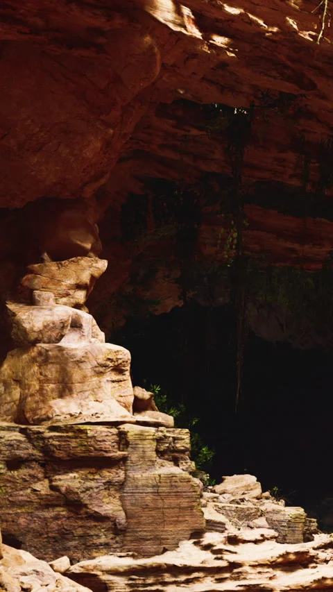 Rock formation under a cave with visible vegetation in a natural setting 스톡 동영상 347052269