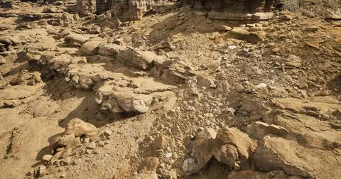 Rock formations and erosion patterns in a desert landscape during daylight Stock Illustration