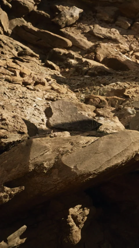 Rock formations and textures under a clear sky in a desert landscape Stock Footage 334261679