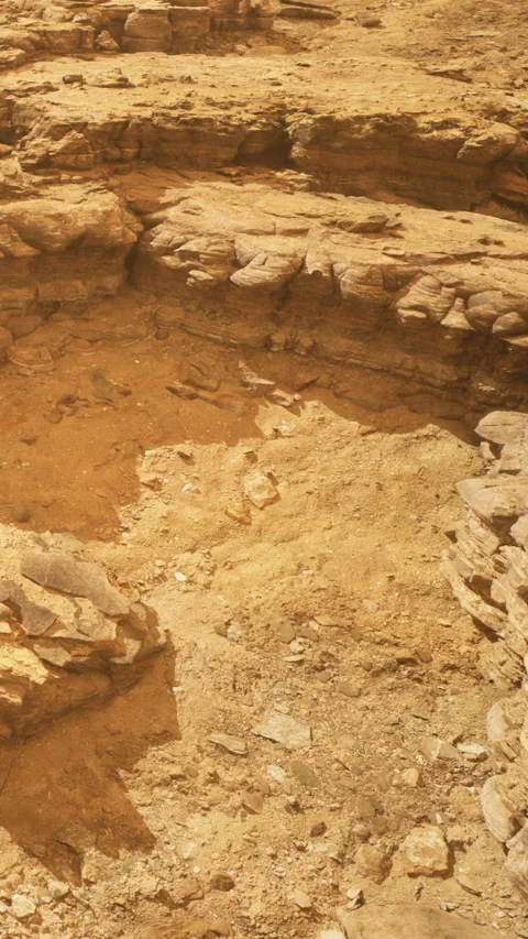 Rock formations in arid landscape with dry soil and erosion patterns 動画素材 334262111