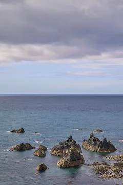 Rock formations in the Atlantic ocean with clouds and copy space Stock Photos