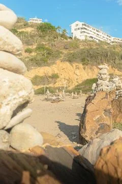 Rock formations on the beach at sunset Stock Photos