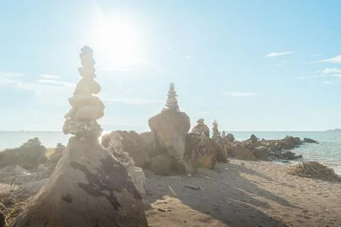 Rock formations on the beach at sunset Stock Photos