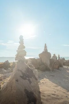 Rock formations on the beach at sunset Stock Photos