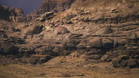 Rock formations create a dramatic landscape in a rugged desert terrain Illustrazione stock