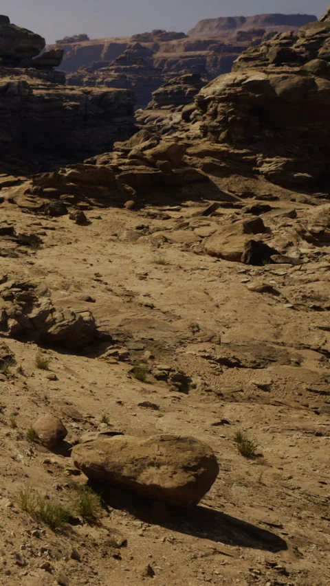 Rock formations in a dry landscape under bright sunlight in a desert area Stock Footage 331753497