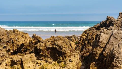 Rock formations in front of Liencres beach on a sunny summer day, Spain. Stock Photos